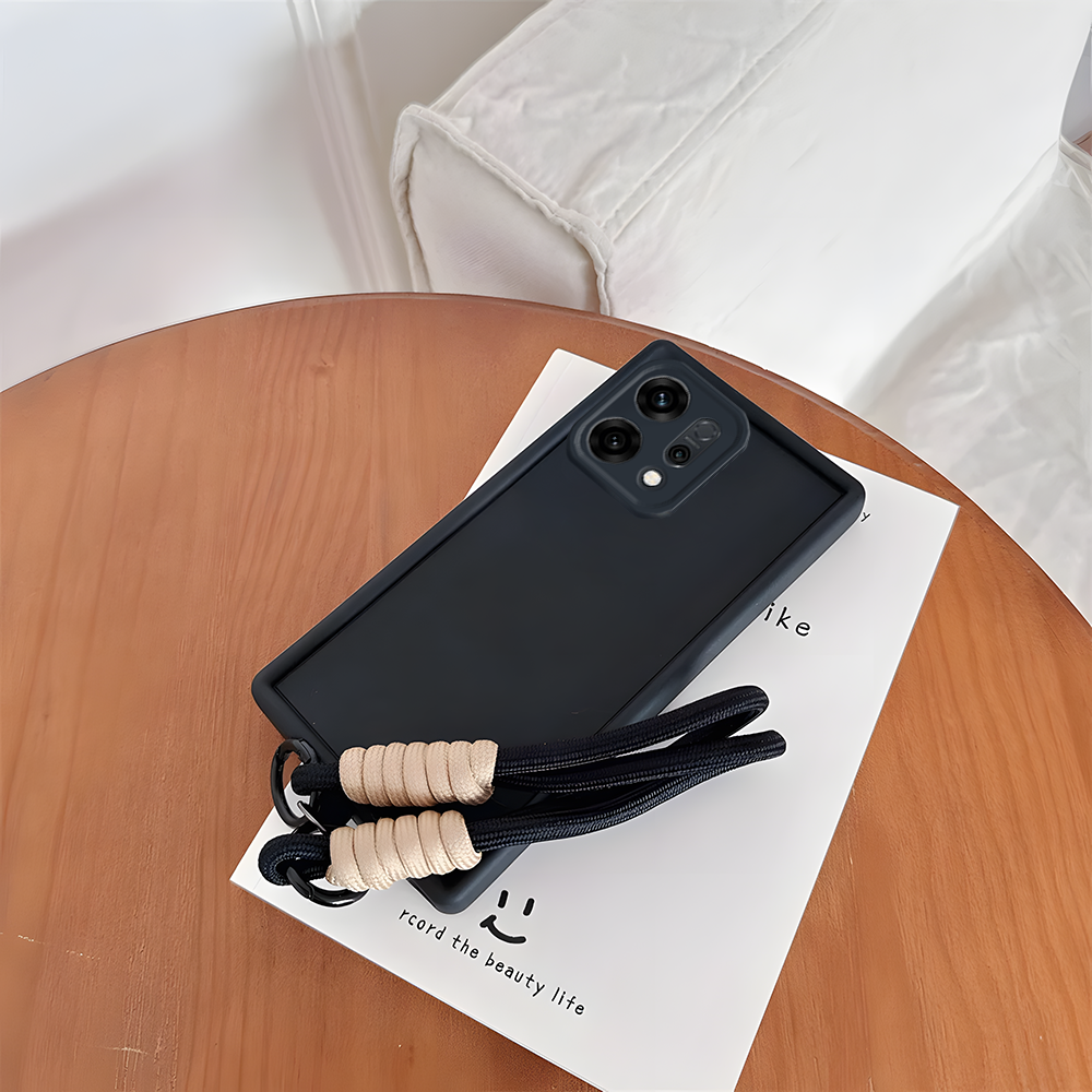 Oppo Reno 14 5G Black phone case with a strap on a wooden table