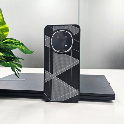 Phone case with geometric design on a white surface with a plant in the background