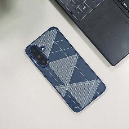 Phone case with geometric design on a light surface next to a laptop