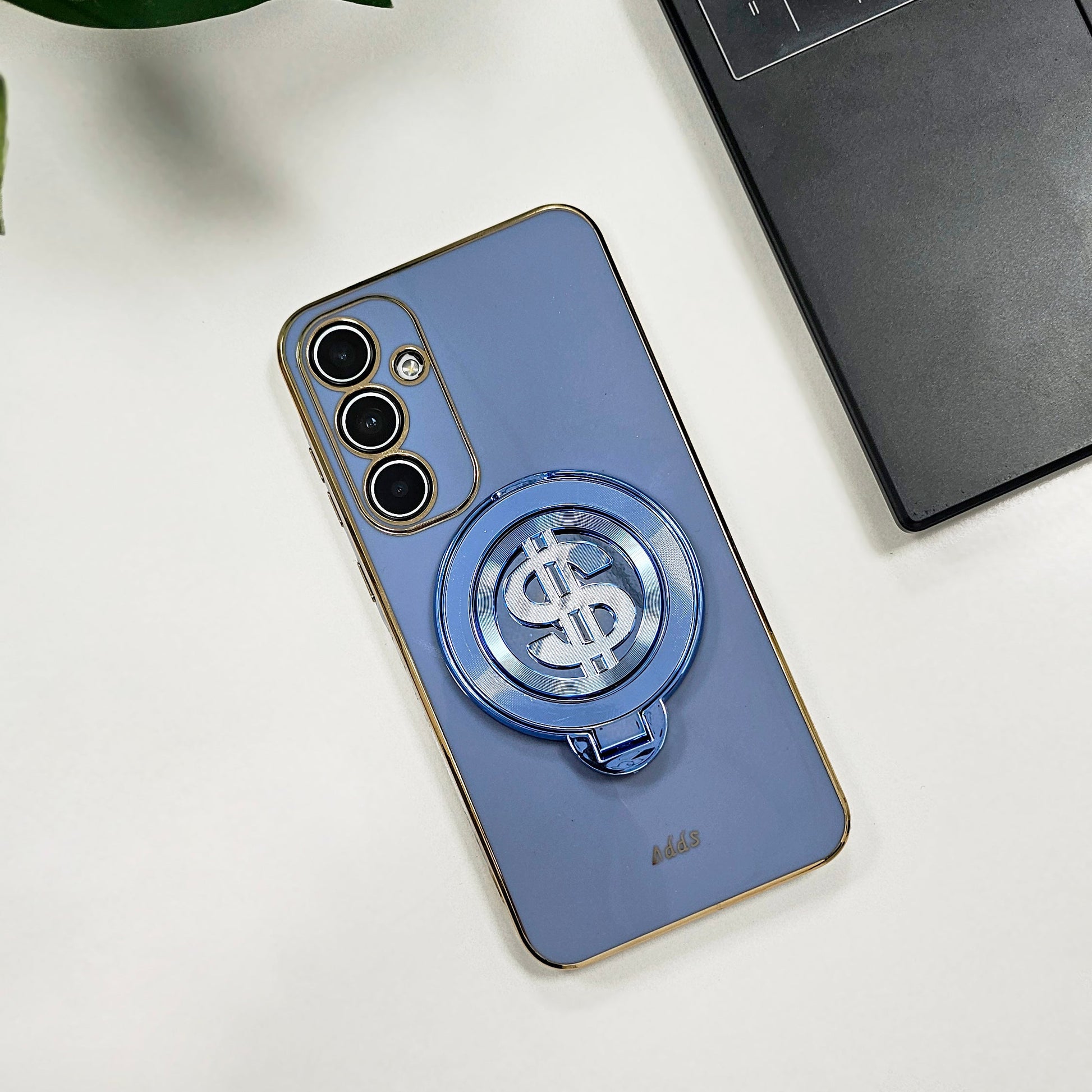 Blue phone case with a dollar sign design on a white surface