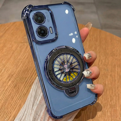 Blue phone case with a compass design held by a hand on a wooden surface