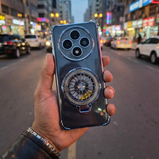 Hand holding a smartphone with a car wheel design on a city street background