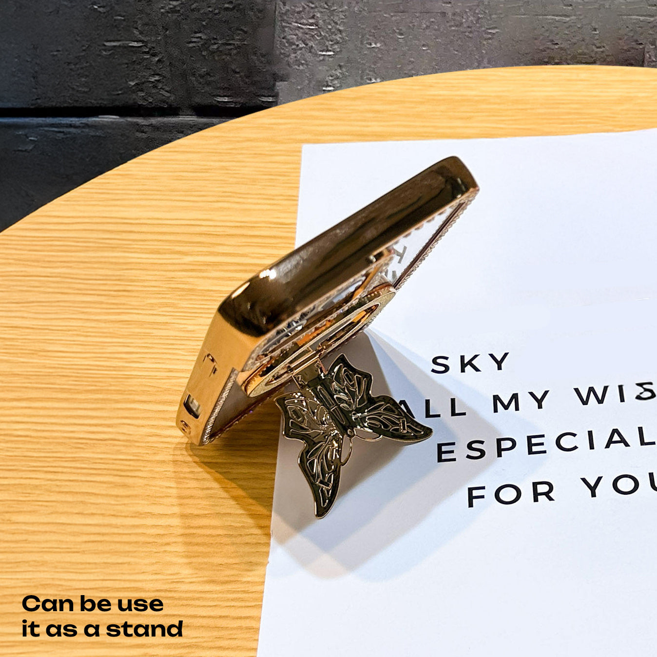 Oppo Reno 14 5G Gold butterfly clip on a wooden surface with text overlay