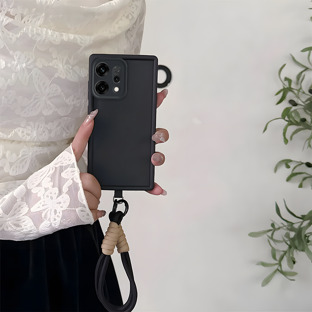 Person holding a black Oppo Reno 14 5G phone case with a lanyard on a light background