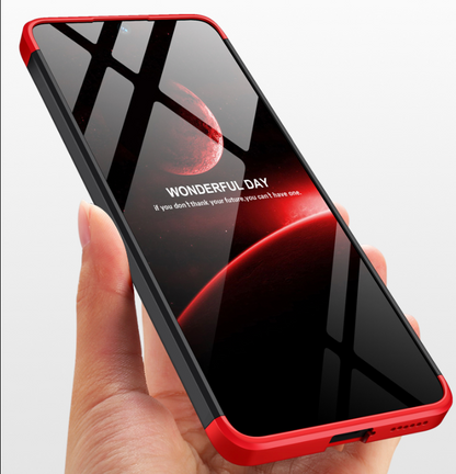 Phone with red and black design held in a hand on a light gray background