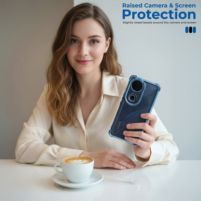 Woman holding a smartphone with raised camera and screen protection, sitting at a table with a cup of coffee.