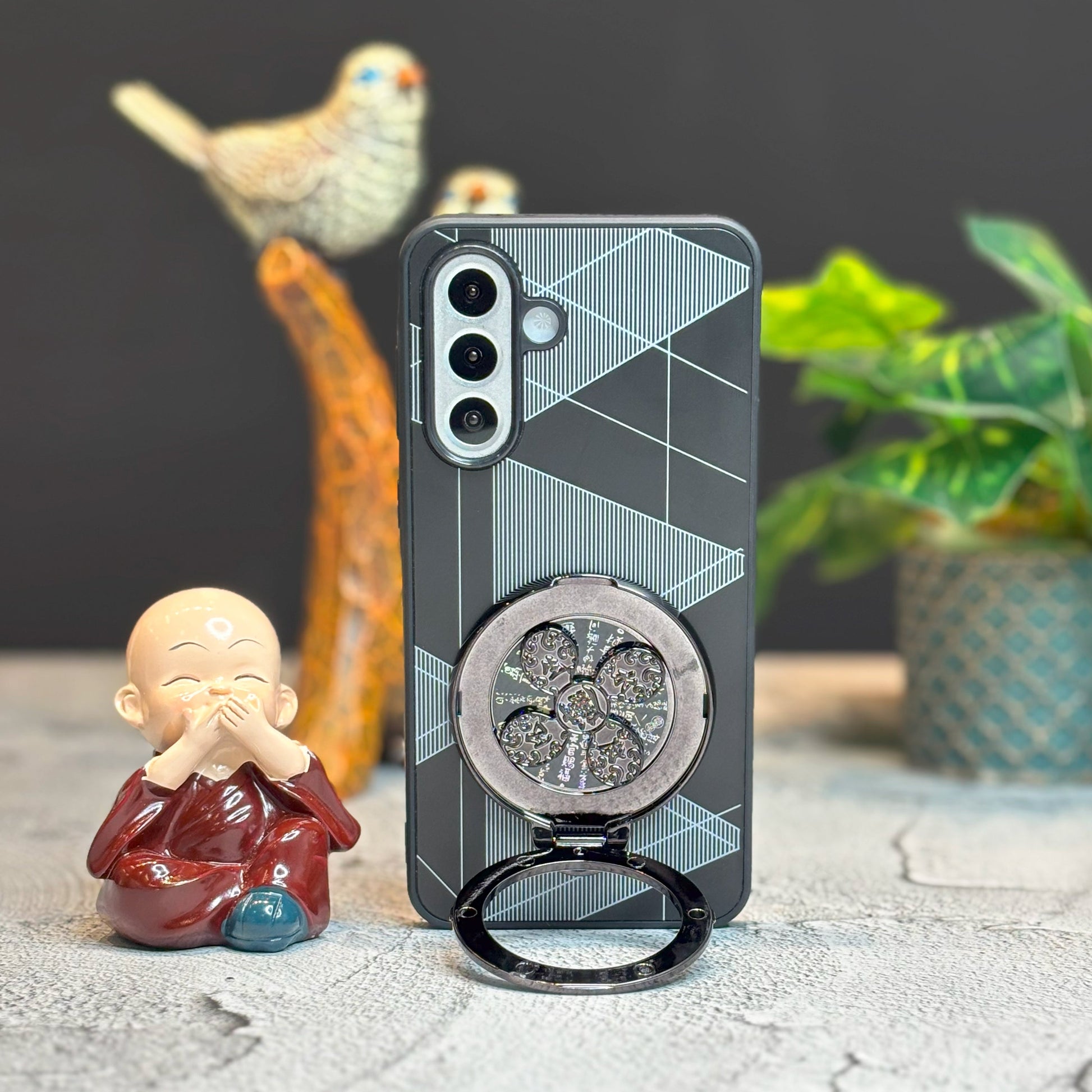 Phone case with ring holder on a surface with decorative items